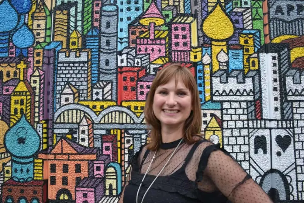 Claire Tin Box Traveller in front of graffiti art - hidden views of London's South Bank