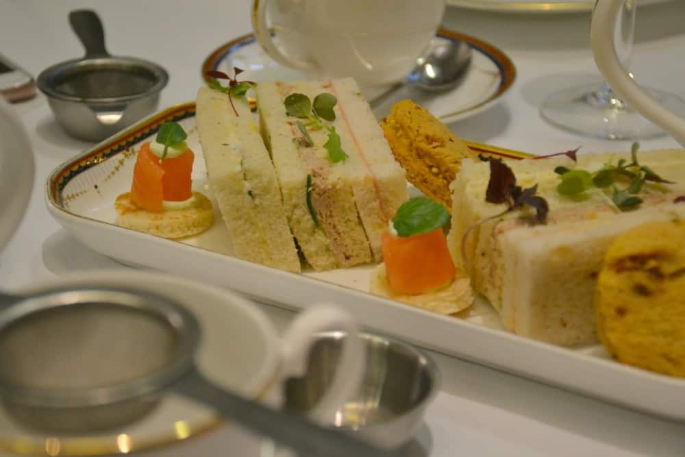small crustless sandwiches on a plate - afternoon tea at the Waldorf Hilton London