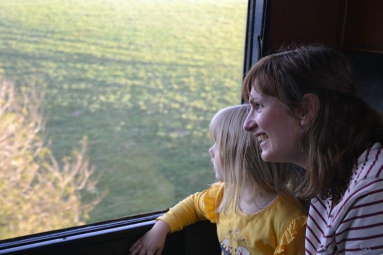 Tin Box Traveller and Tot looking out of train window - the Round Robin South Devon