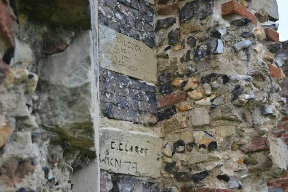 Flint work and graffiti on abbey gatehouse St Benet's monastery gate house ruin - Norfolk Broads with kids