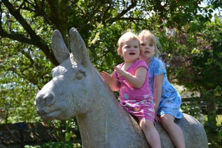 Tin Box girls on a donkey statue at Sidmouth Donkey Sanctuary