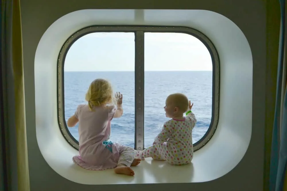 Kids in stateroom window on cruise ship - cruising with a baby