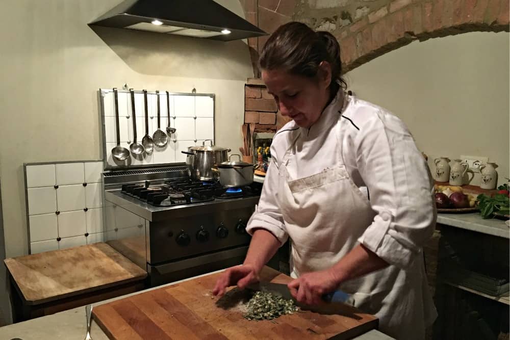 Fabiola cooking in kitchen - A luxury villa holiday in Tuscany with Bookings For You