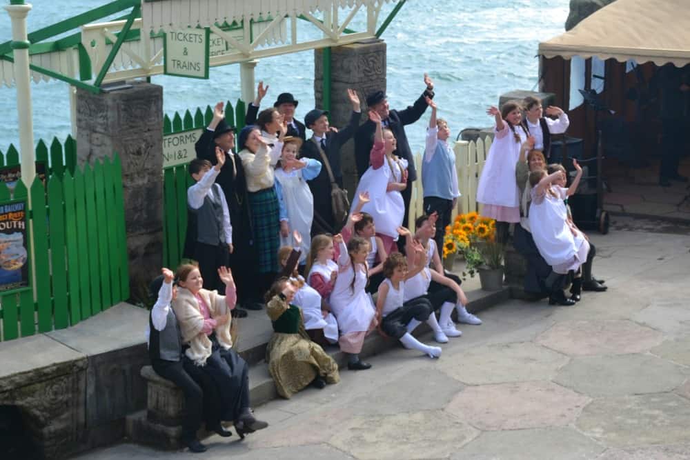 Cast on station - The Railway Children at The Minack Theatre in Cornwall