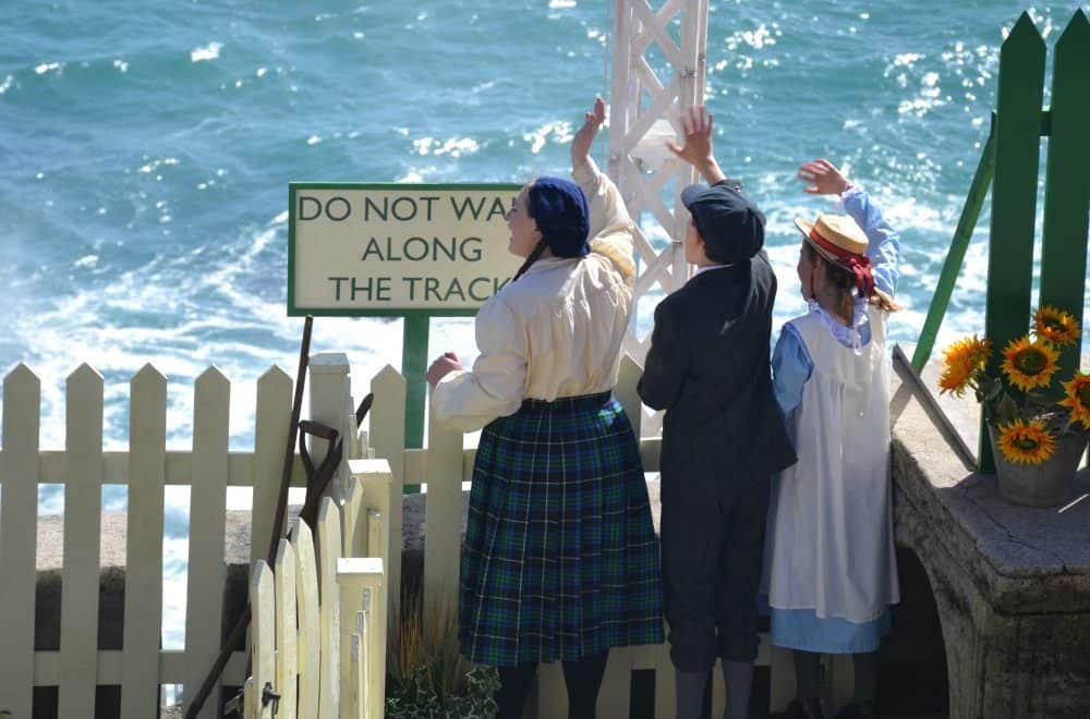 Children waving at station - The Railway Children at The Minack Theatre in Cornwall