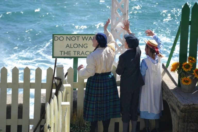 Children waving at station - The Railway Children at The Minack Theatre in Cornwall