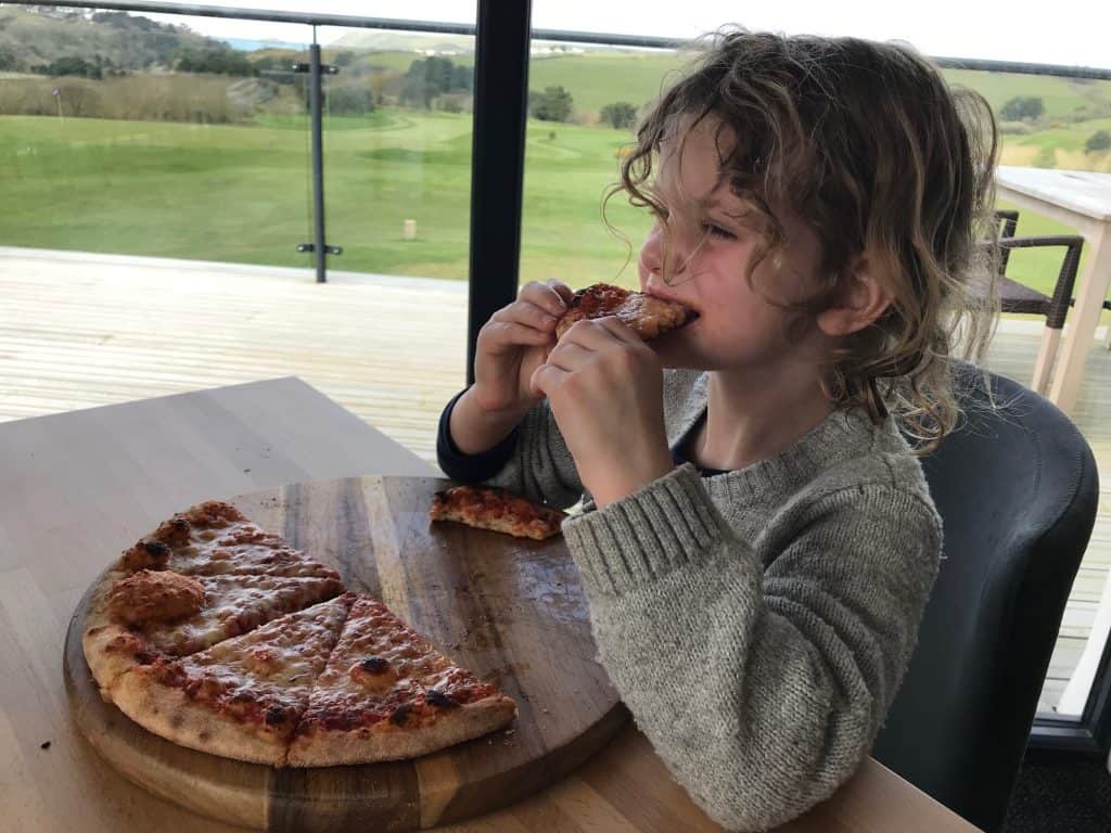 Chloe eating pizza - The Point at Polzeath