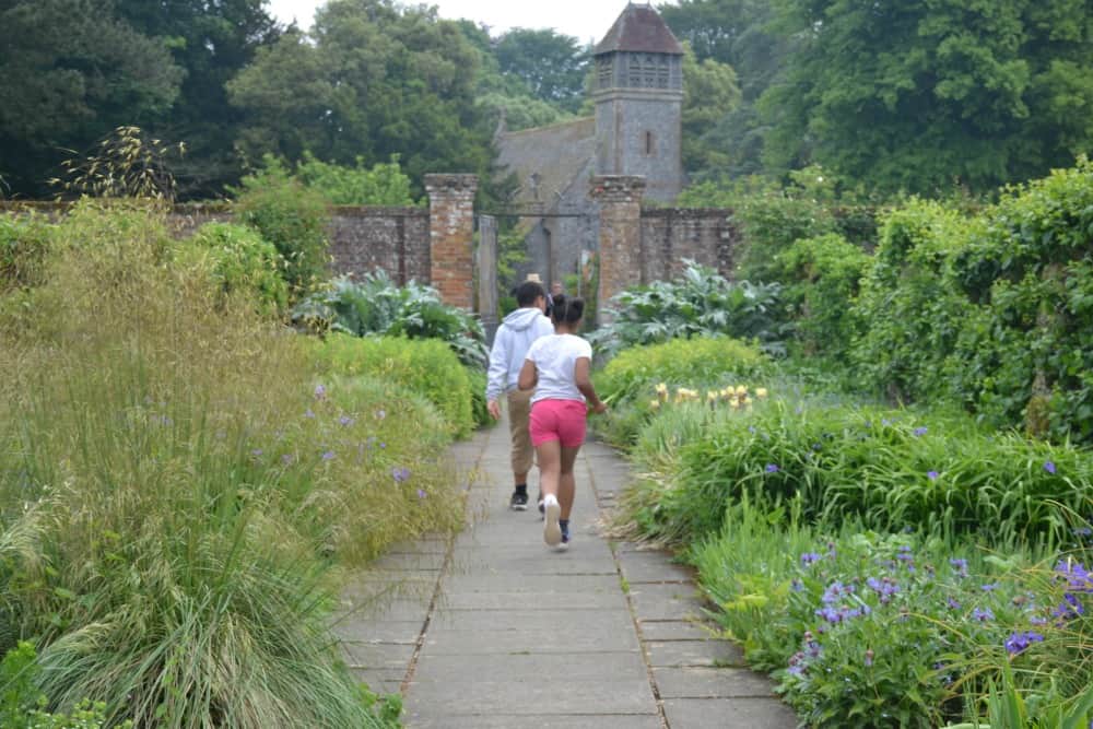 Kids running in walled garden - Hinton Ampner National Trust gardens: things to do in Winchester with children