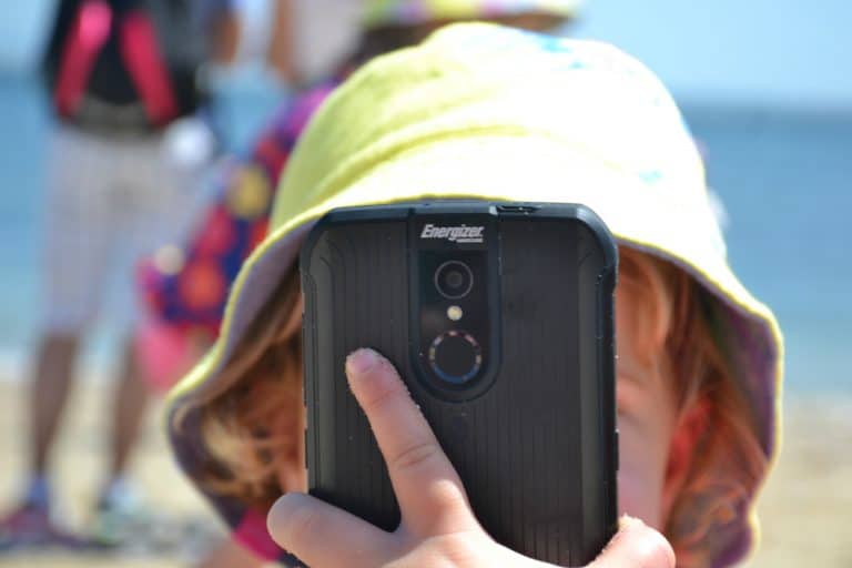 Energizer Energy E520 LTE in front of Tin Box Baby's face