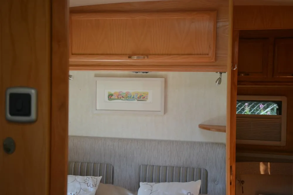 Picture on caravan bedroom wall - VELCRO® Brand products - caravanning accessories to organise and tidy your caravan