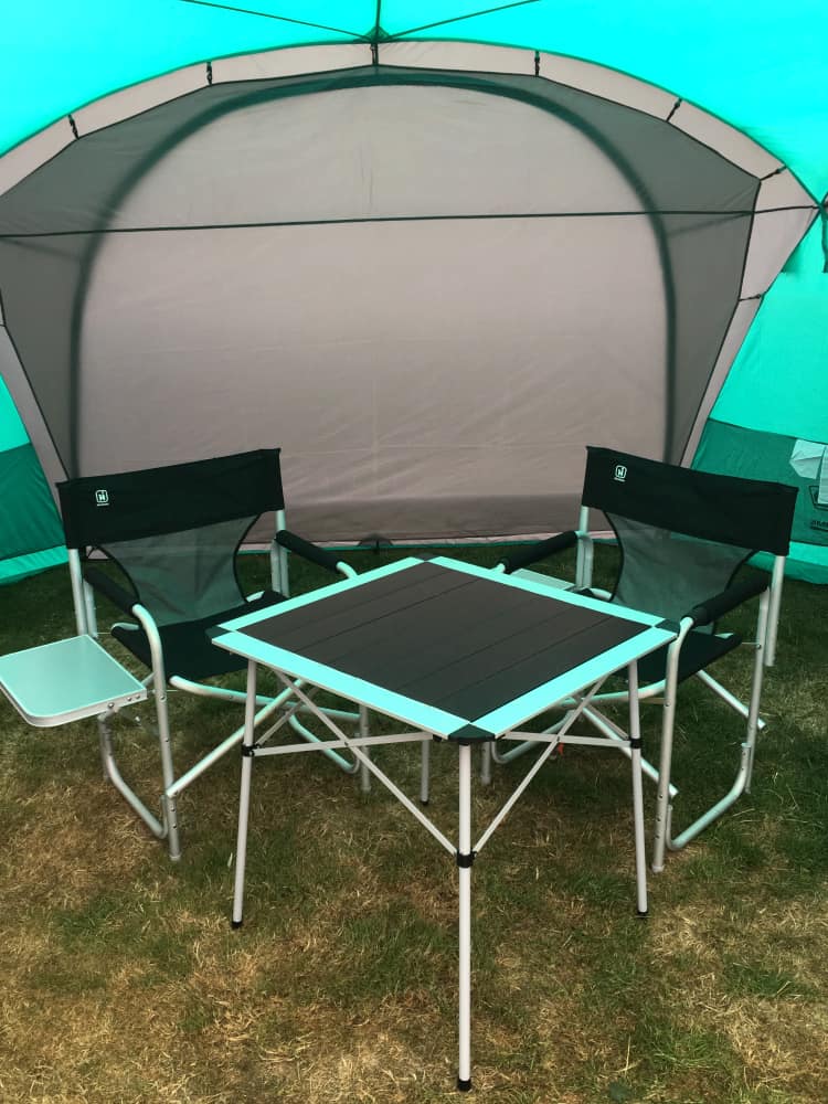 Table and chairs in Coleman Event Dome XL shelter outside caravan - the best gazebo for camping?