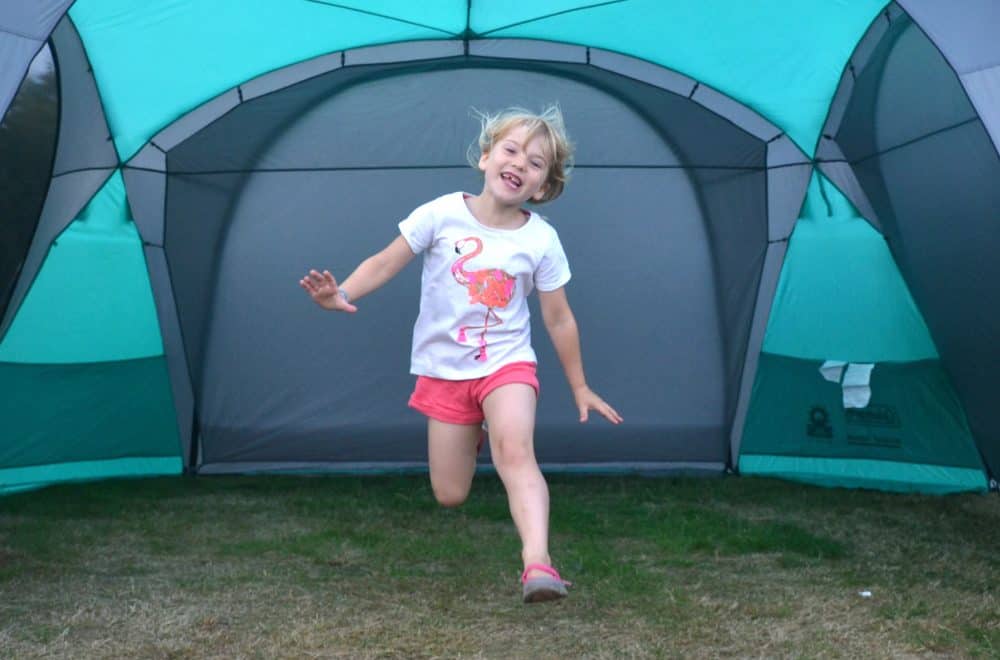 Tin Box Tot jumping in Coleman Event Dome XL shelter outside caravan - the best gazebo for camping?