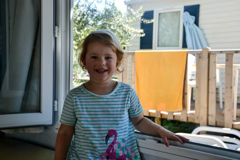Child stood by mobile home window