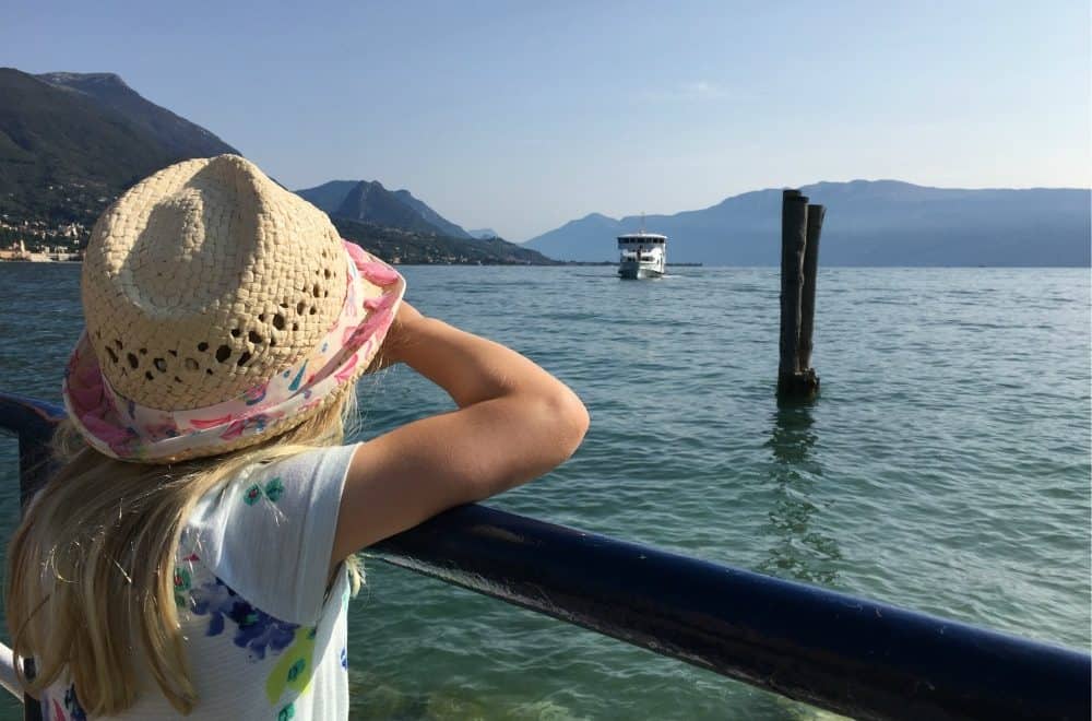 Tot looking at boat on Lake Garda - things to do in Lake Garda
