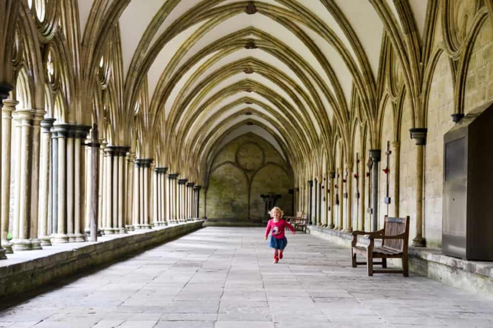 Baby running in cloisters Salisbury Cathedral - Salisbury with kids - a short break in October half term