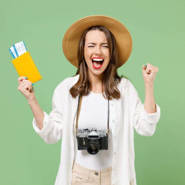 Excited traveller holding tickets and passport