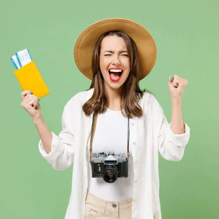 Excited traveller holding tickets and passport