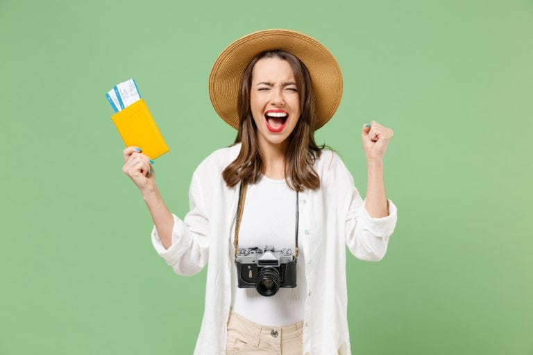 Excited traveller holding tickets and passport