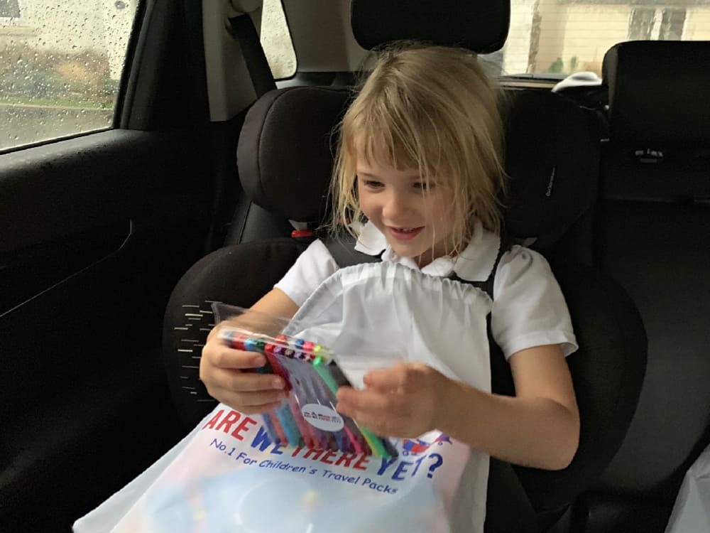 Tot with pack of pens from Are we there yet? children's activity pack for travel