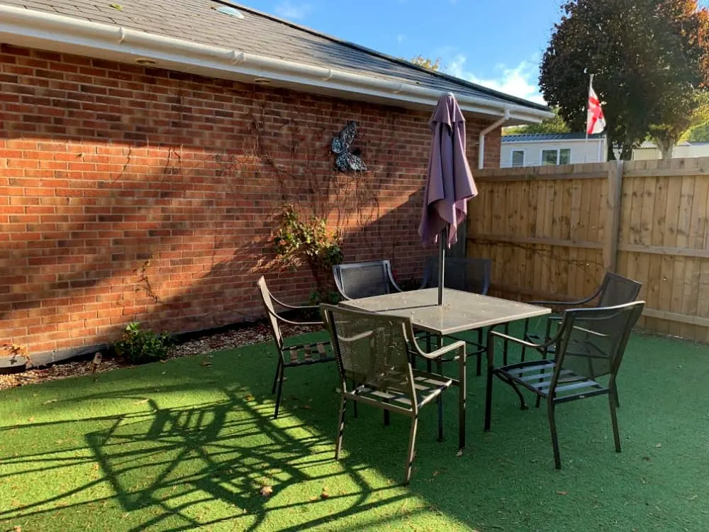 Private garden seating - Luxury caravan with hot tub at Andrewshayes Holiday Park Devon