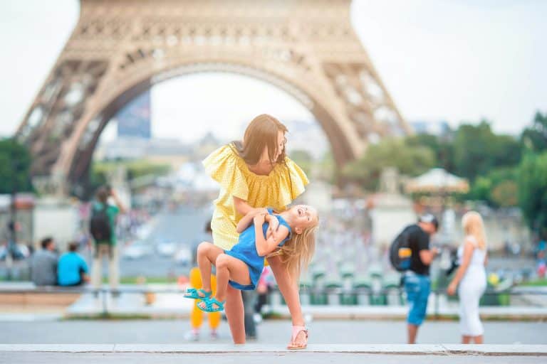 Happy mother and little adorable girl on vacation in Paris near Eiffel Tower