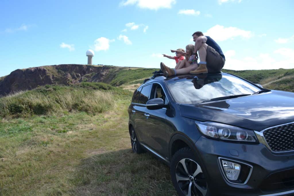 Tin Box family on top of car - tips for family holidays with kids from the Caravan, Camping and Motorhome Show