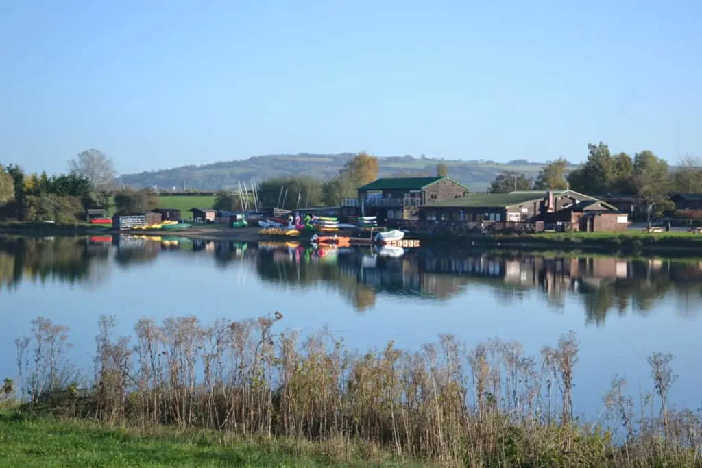 View across lake to water sports and club house - glamping in Gloucestershire: Croft Farm Water Park rewiew