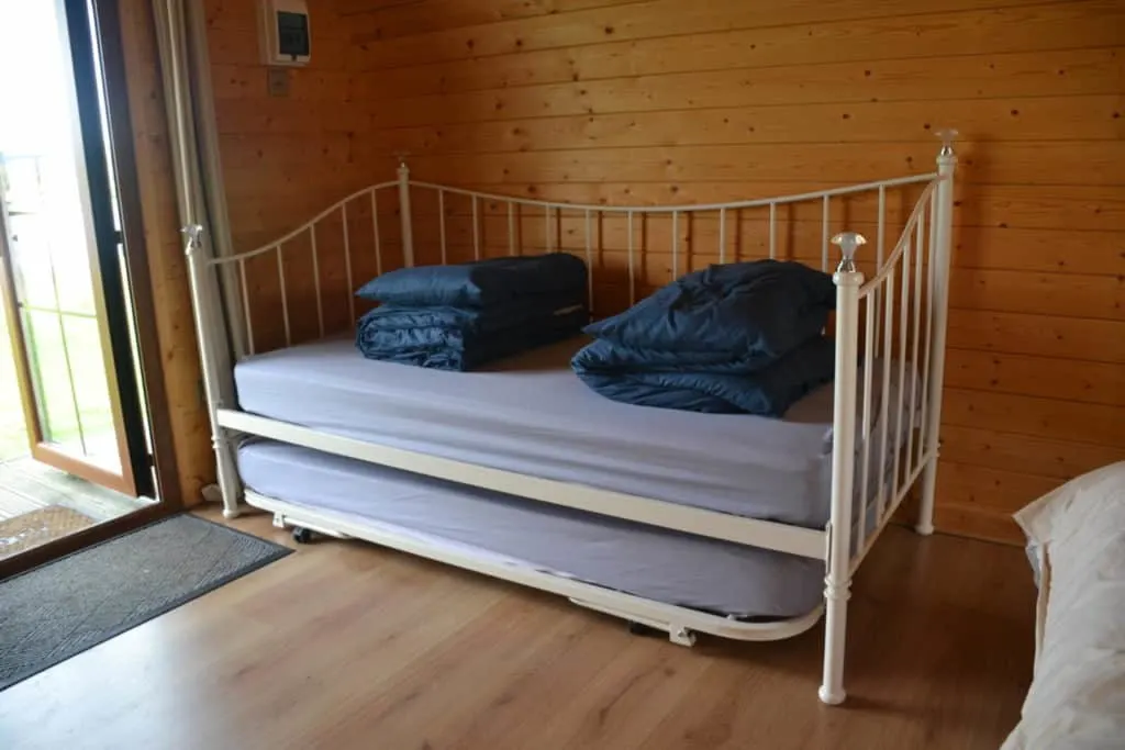 Day bed in lakeside glamping pod at Croft Farm Water Park in Gloucestershire