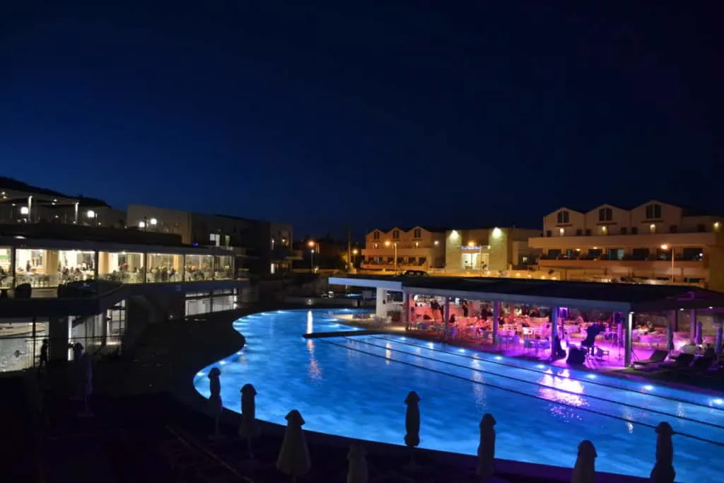 Pool and bar at night at Kiani Beach Resort - an all inclusive family resort in Crete