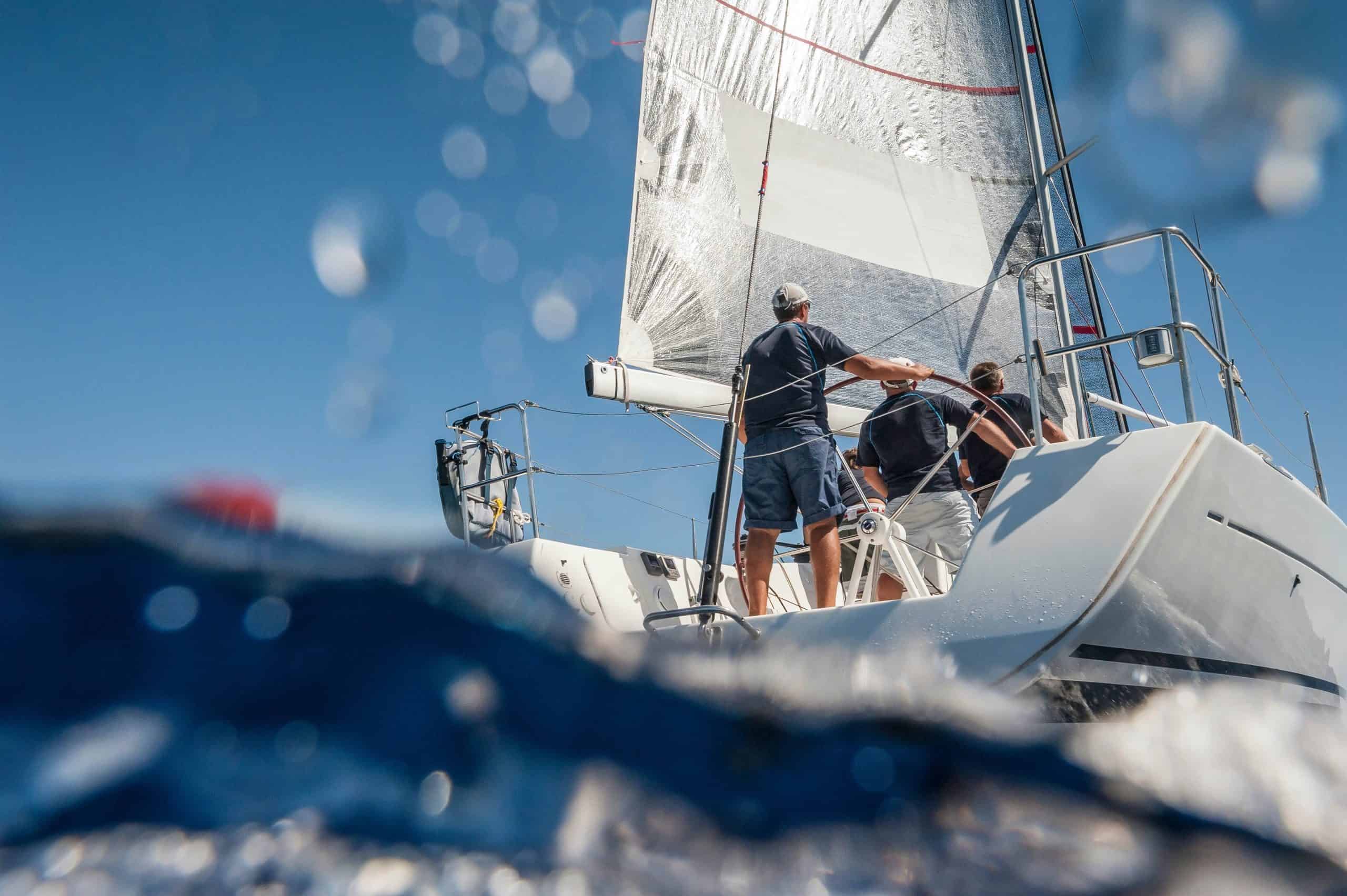 Aft of sailing boat with skipper from underwater view