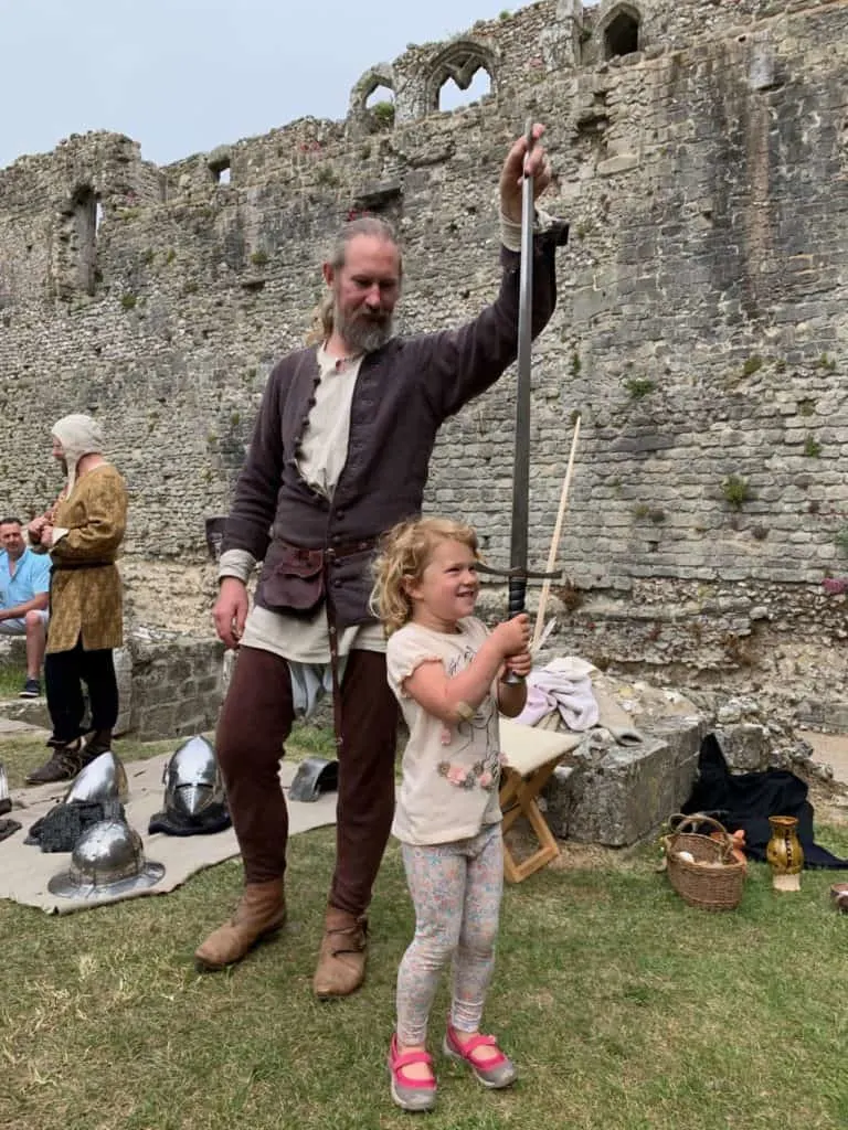 Baby holding sword during special even at Portchester Castle