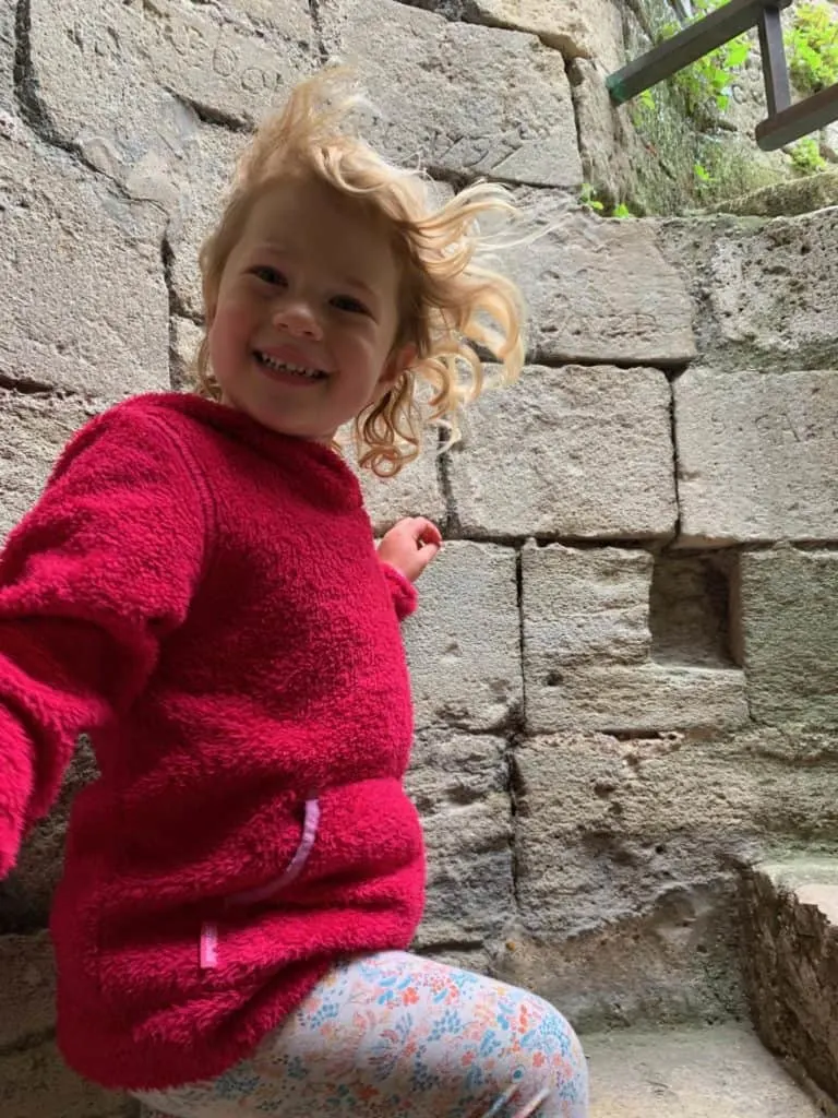 Baby climbing Spiral staircase in Portchester Castle keep