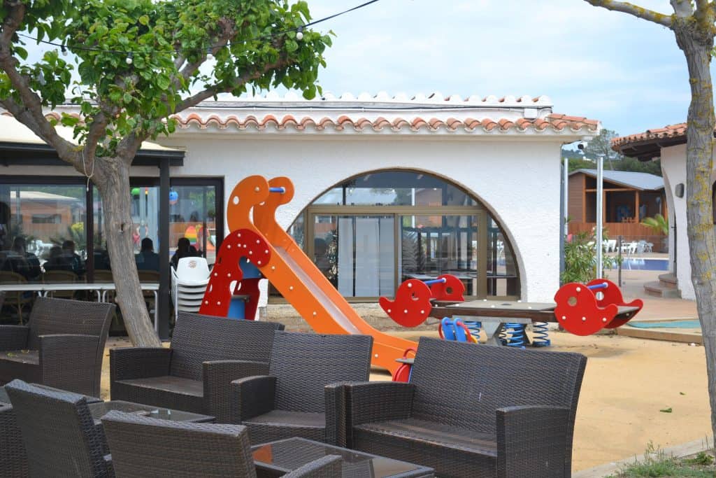 Play area in front of the restaurant at Camping Bon Repos in Costa Barcelona