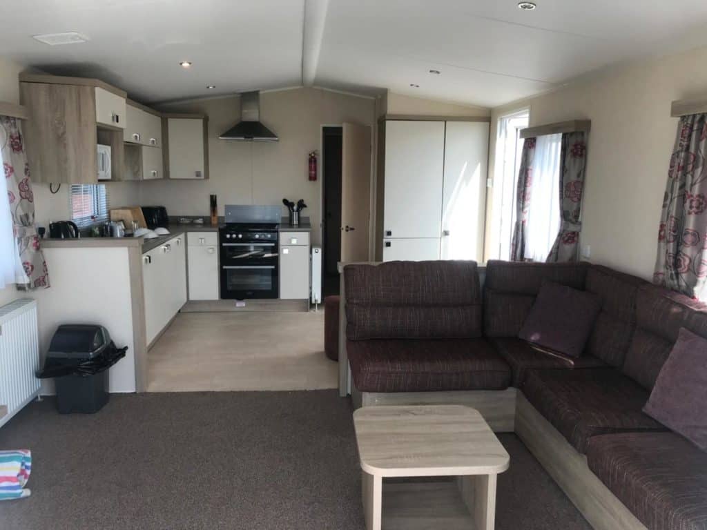 Living area with kitchen in Gold Plus holiday home at Pentewan Sands