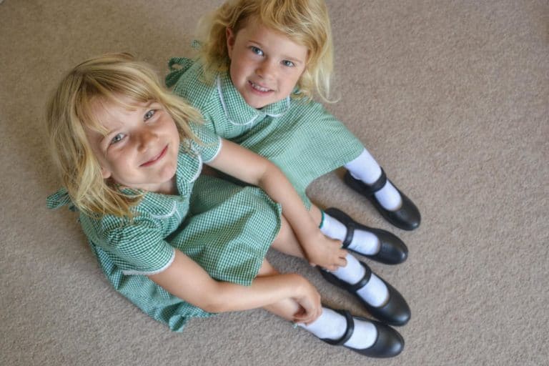 Girls sitting down in school uniform