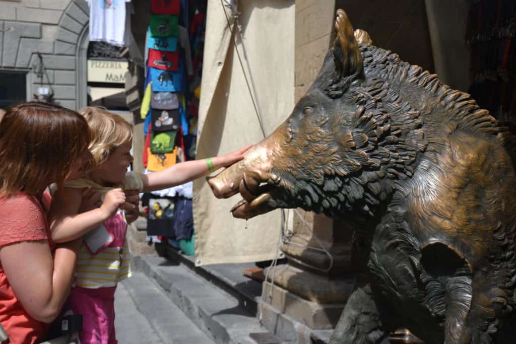 Touching the boar nose of the Porcellino Fountain in Florence