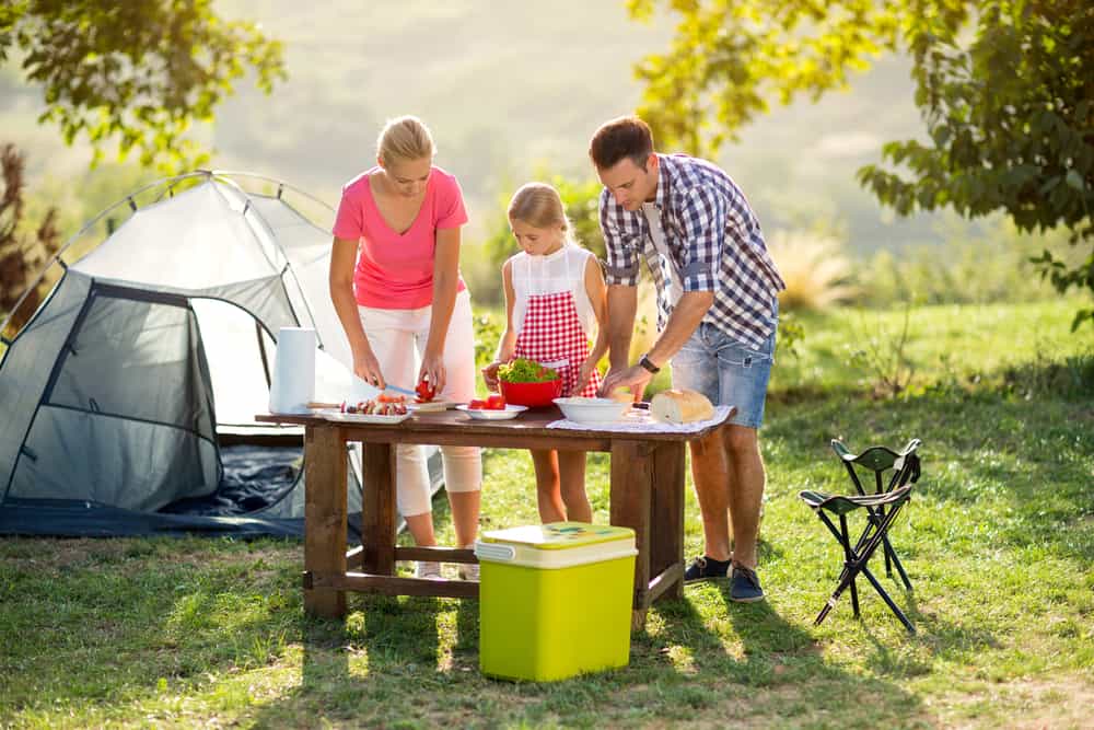 Family preparing food while camping