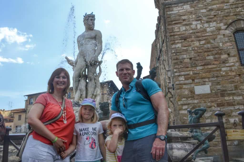 Family in front of fountain in Piazza Signoria, Florence
