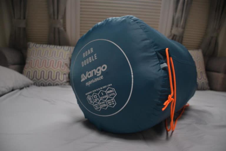 Vango Roar double sleeping bag rolled up on caravan bed