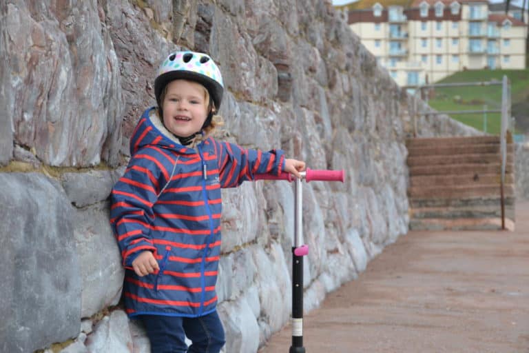 Tin Box Baby holding her cool scooter