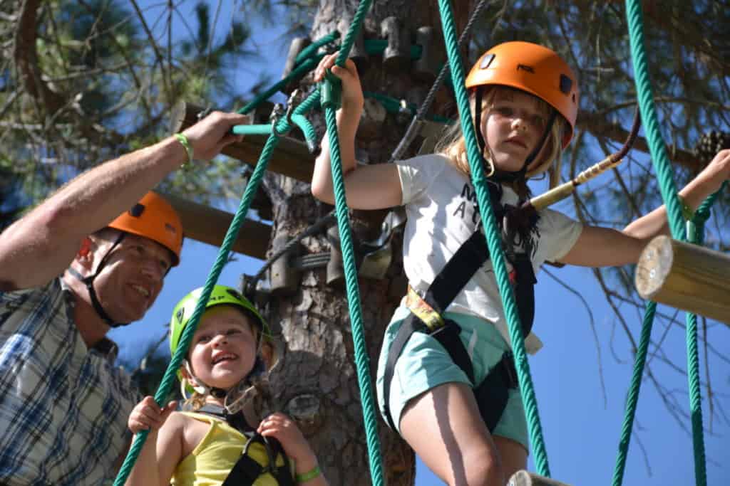 Kids doing high ropes course at holiday village in Italy