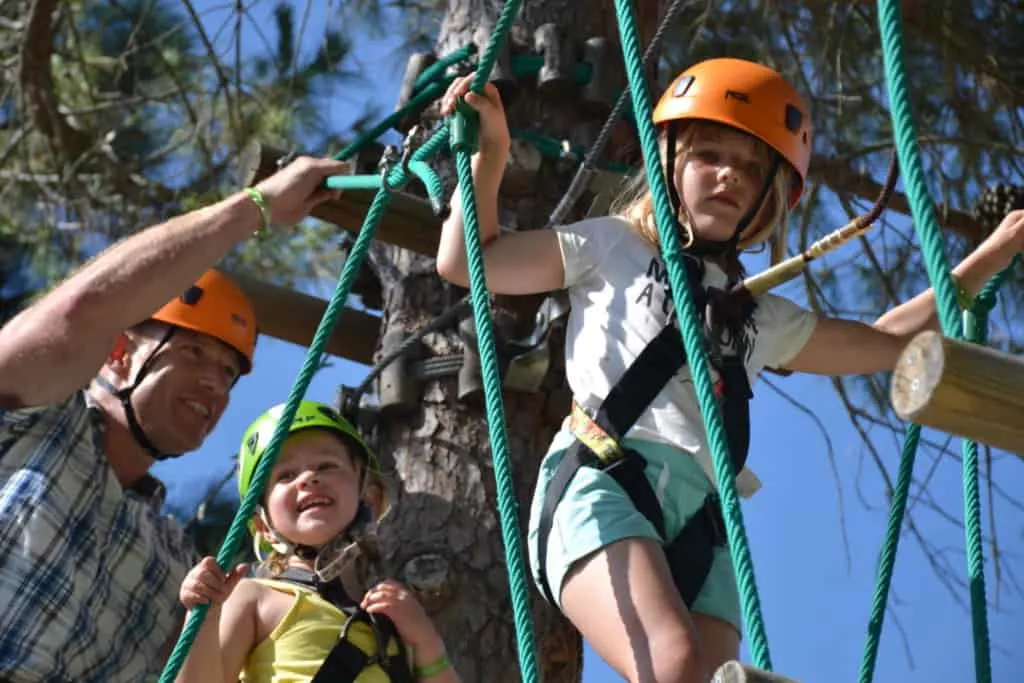 Kids doing high ropes course at holiday village in Italy