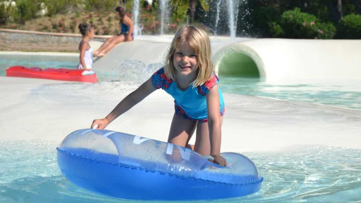 Tot on rubber ring in pool