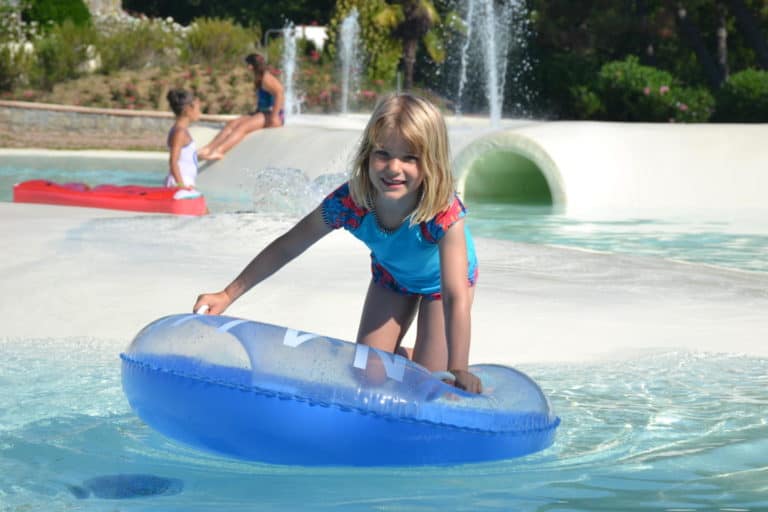 Tot on rubber ring in pool