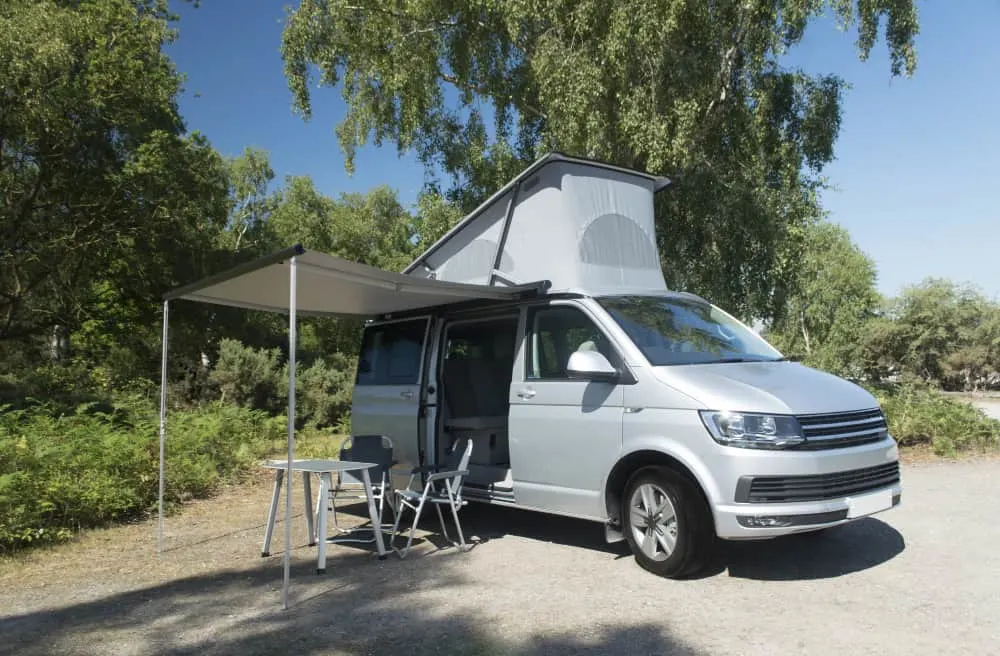 Camper van with roof up at campsite