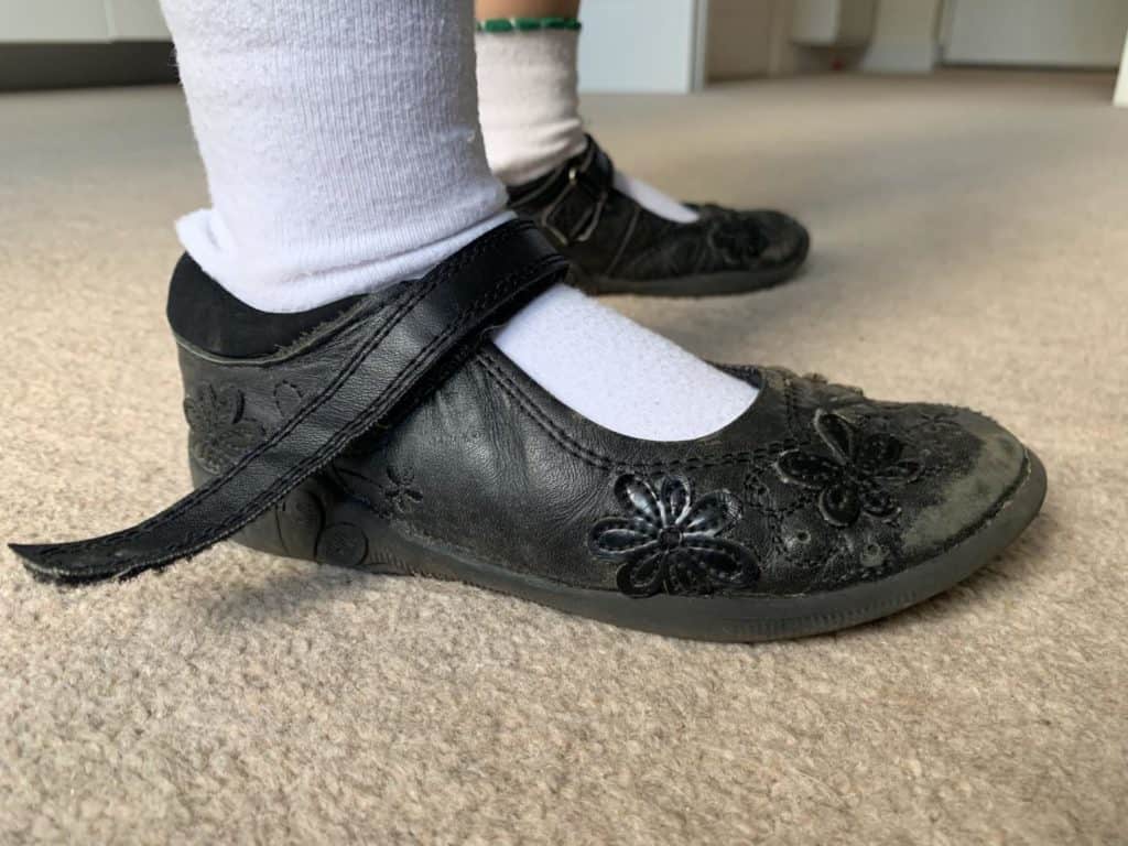 Worn sides of supermarket school shoes