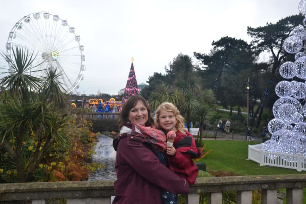 Claire and Tin Box Baby with Bournemouth's Christmas Tree Wonderland and big wheel in background