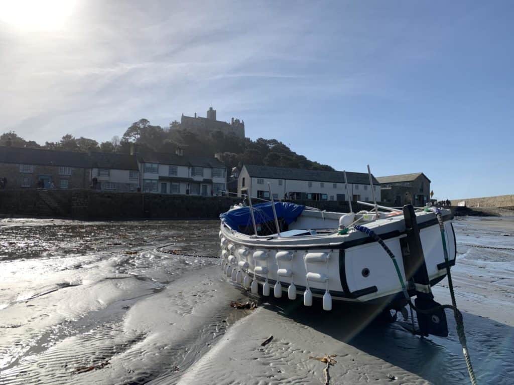 Fishing boat in harbour in front of St Michael's Mount in Cornwall