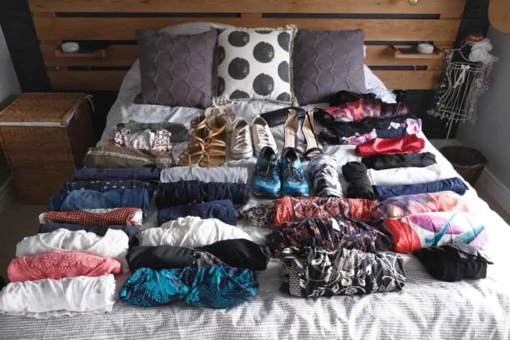 Clothes for a 15 night Caribbean clothes laid out on bed