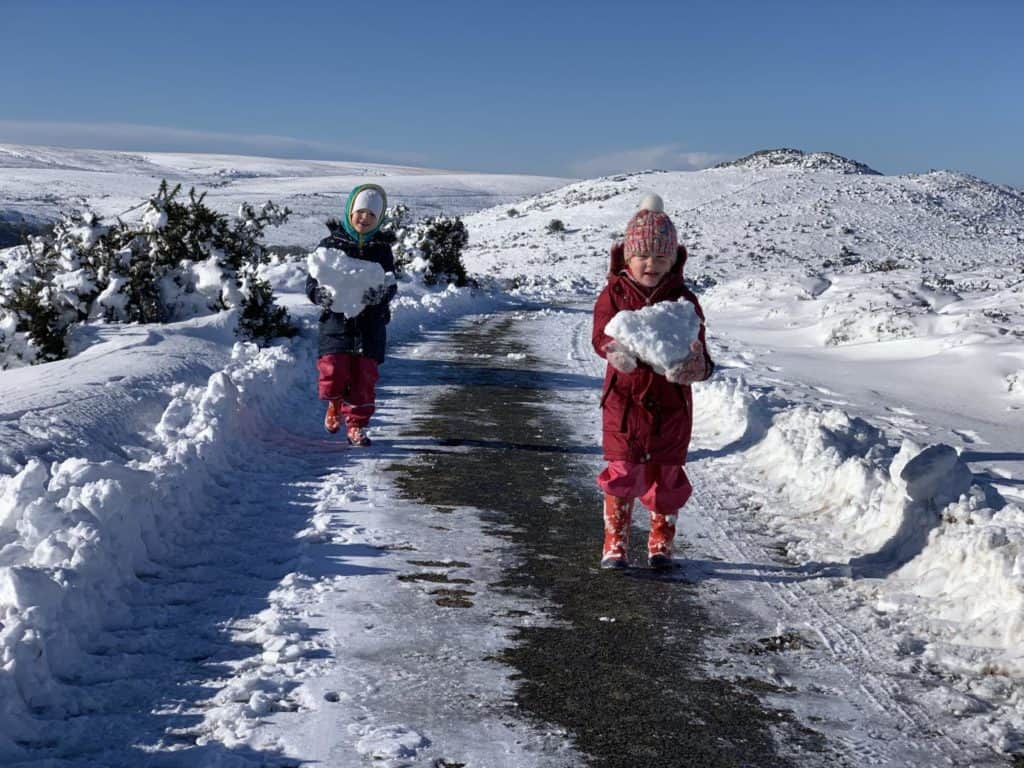 Tin Box Baby and Tot holding snow on a snow covered Dartmoor